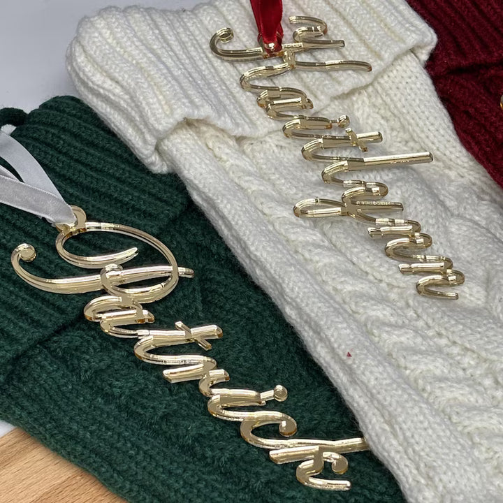 Gold name ornaments on green and white textured fabric